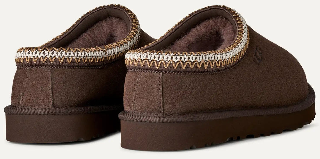 Pair of brown slippers with a textured sole on a light gray background