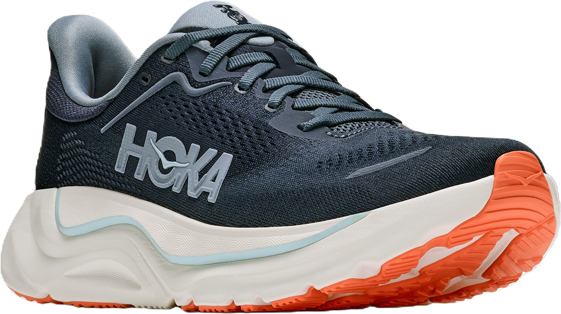 A Hoka running shoe in dark gray and white with a bright orange outsole, shown from a three-quarters angle on a white background.