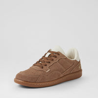 A low-top suede sneaker in brown with a white interior lining and a gum sole, shown from a three-quarters angle on a light gray background.