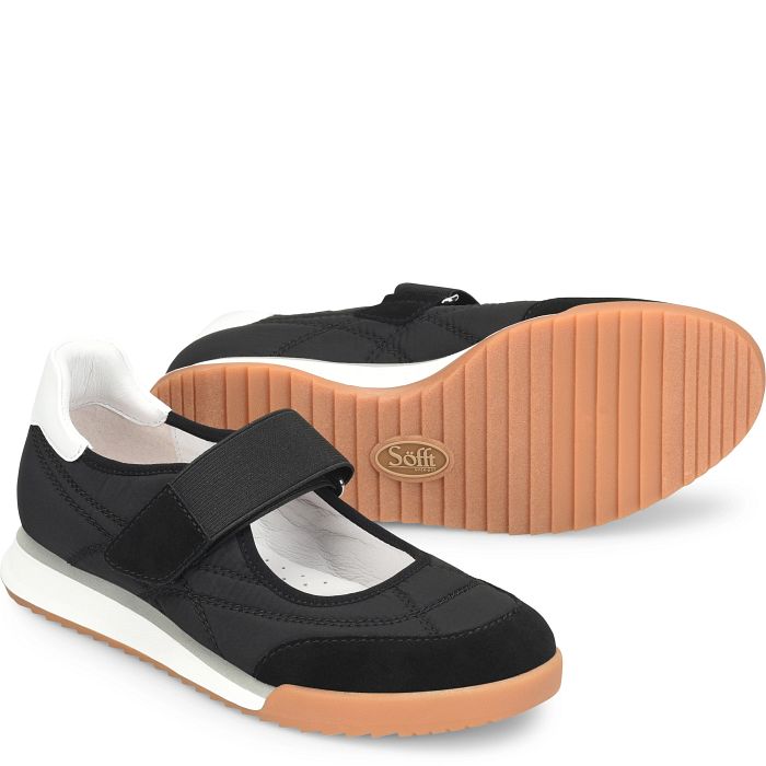 Black and white shoes with brown soles on a white background